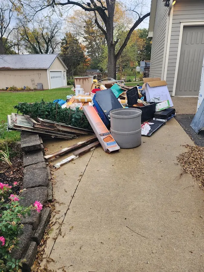 Dumpster being loaded with debris for 12 Yard Dumpster Rental in Bloomfield Hills